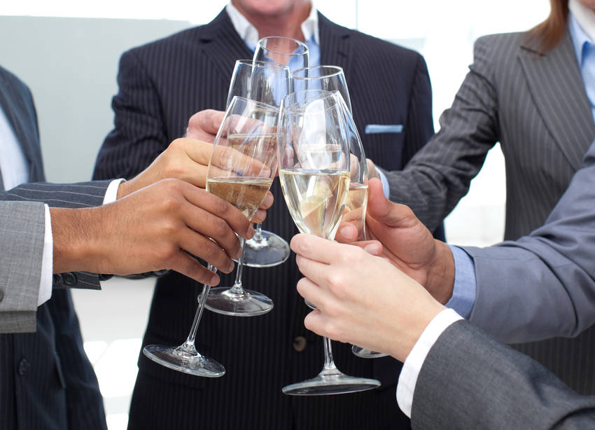 Close-up of business team toasting with Champagne